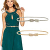 A woman models a teal dress with a gold chain waist belt and a matching gold leather belt.