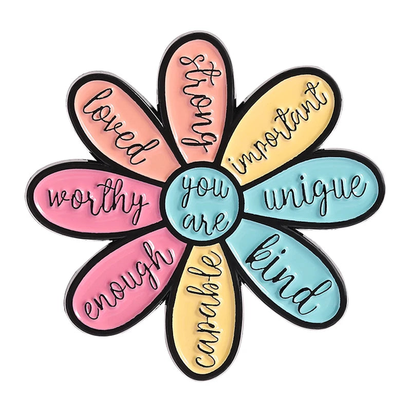 A set of five enamel flower brooches featuring words like loved worthy enough important you are unique and kind.