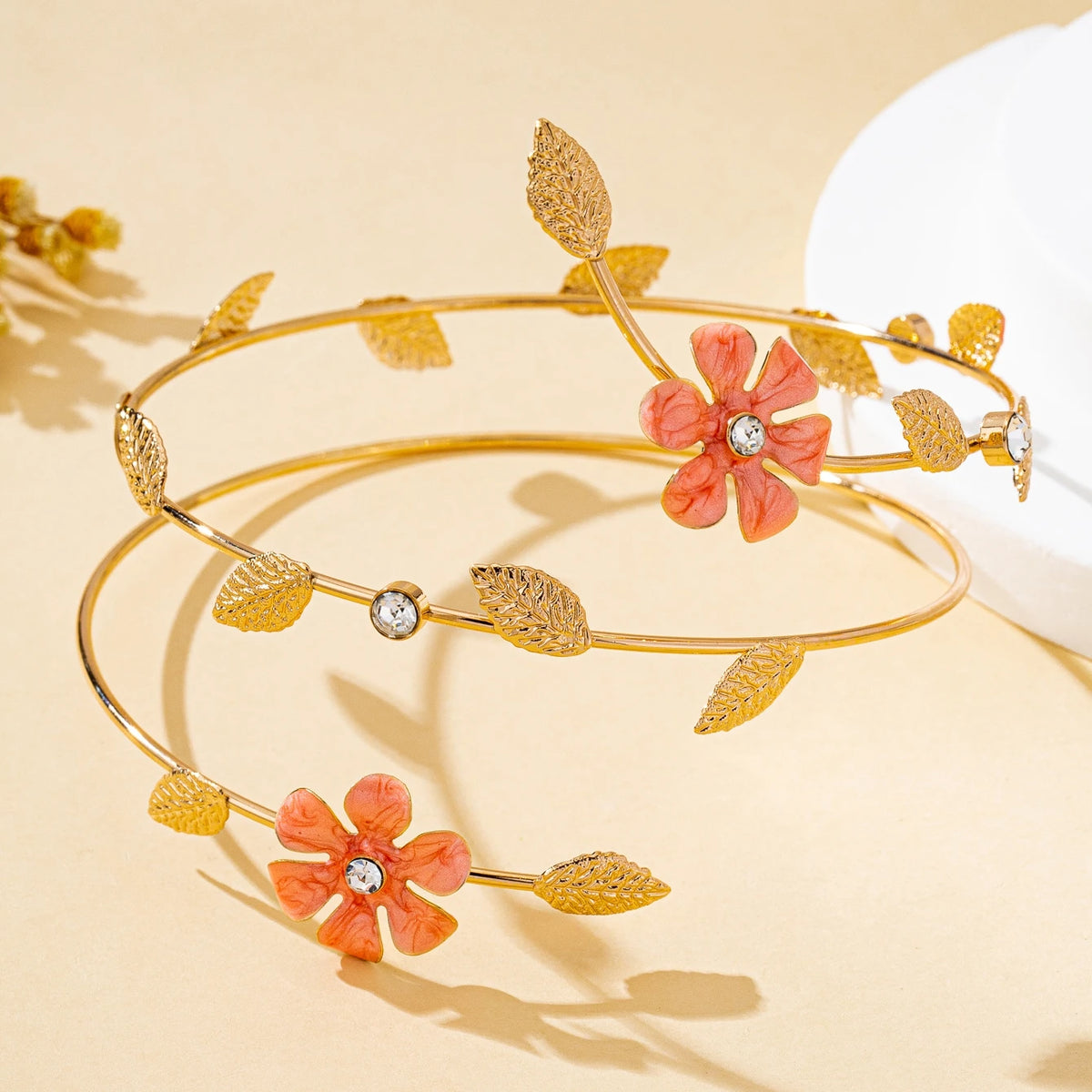 Gold floral vine arm bracelet with small orange flowers and gold leaves