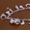 A silver geometric charm bracelet featuring various charms including hearts, stars, and a cube shape.