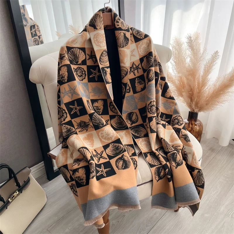 A beige and black plaid cashmere scarf draped over a white chair in a bright room.