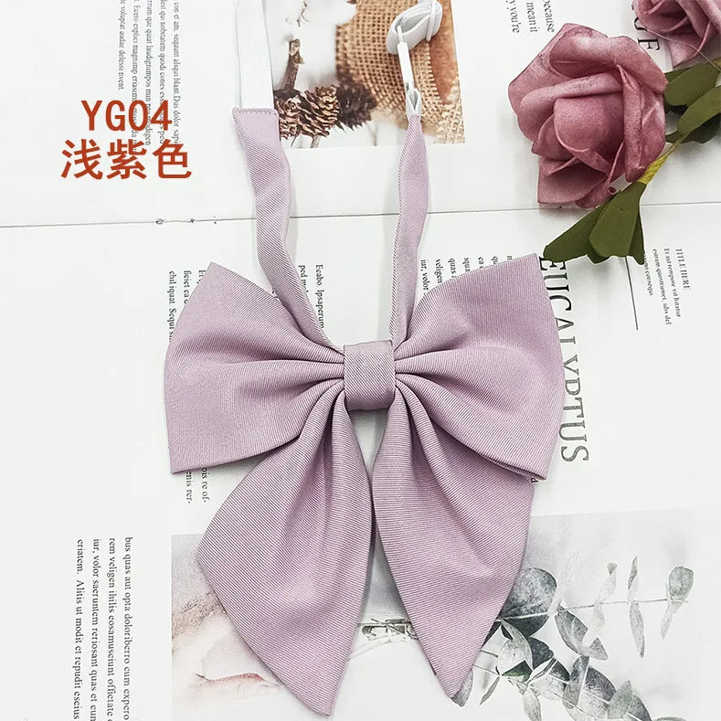 A solid lavender cotton bow tie tied in a decorative knot, displayed against a light background.