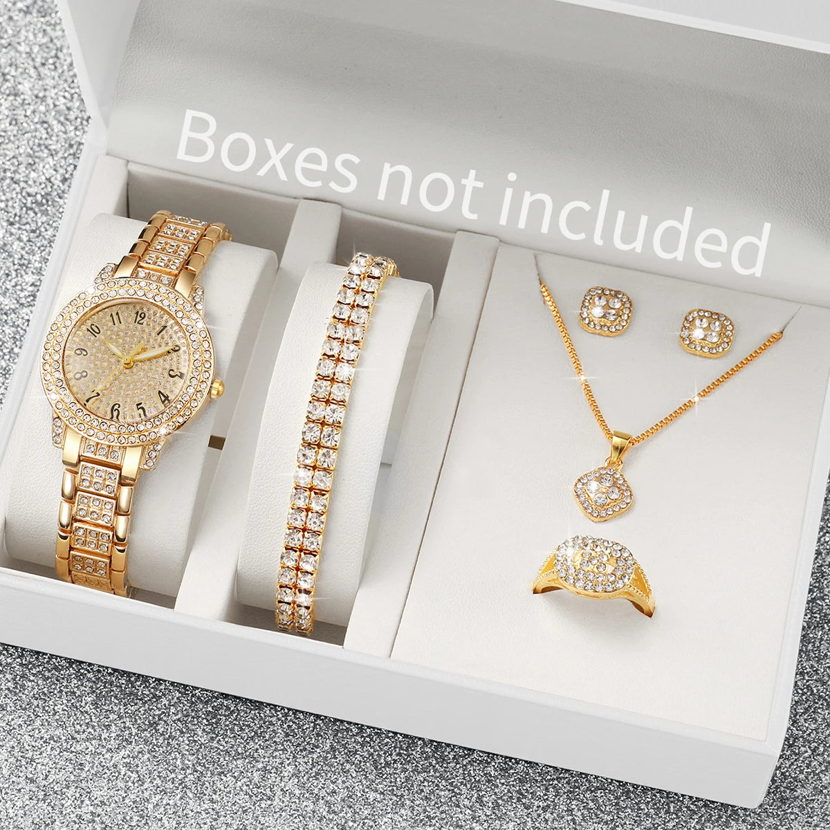 A white box displays a set of gold-toned quartz watches, including a wristwatch, bracelet, and earrings, with the text Boxes 