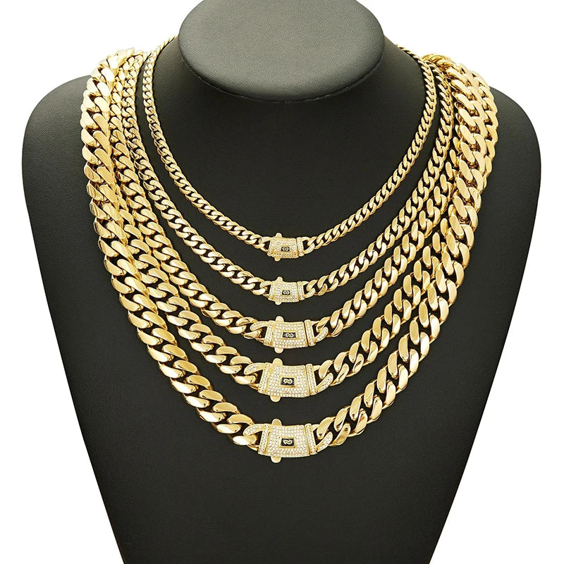 A close-up of a gold Cuban link chain necklace displayed on a black display stand.