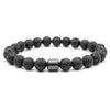 A black lava map bracelet made of smooth, dark stones with a silver-toned clasp.