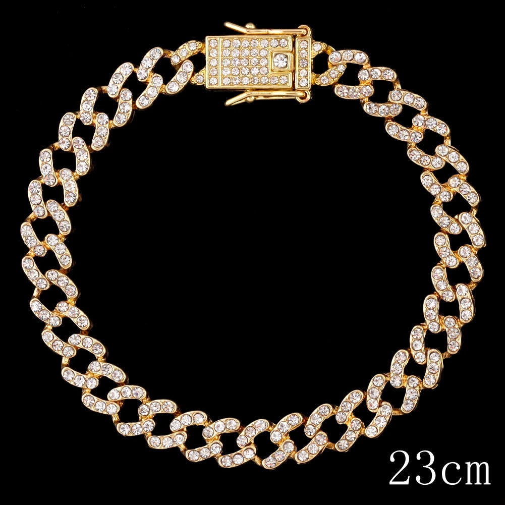 A gold crystal Cuban link anklet with a rectangular clasp and a 23cm chain is displayed against a black background.