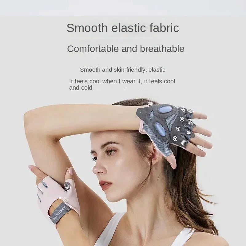 A woman is wearing silicone sculpting gloves on her hand while looking at them.
