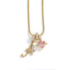 Gold letter A and flower pendant necklace with pink gemstone accents