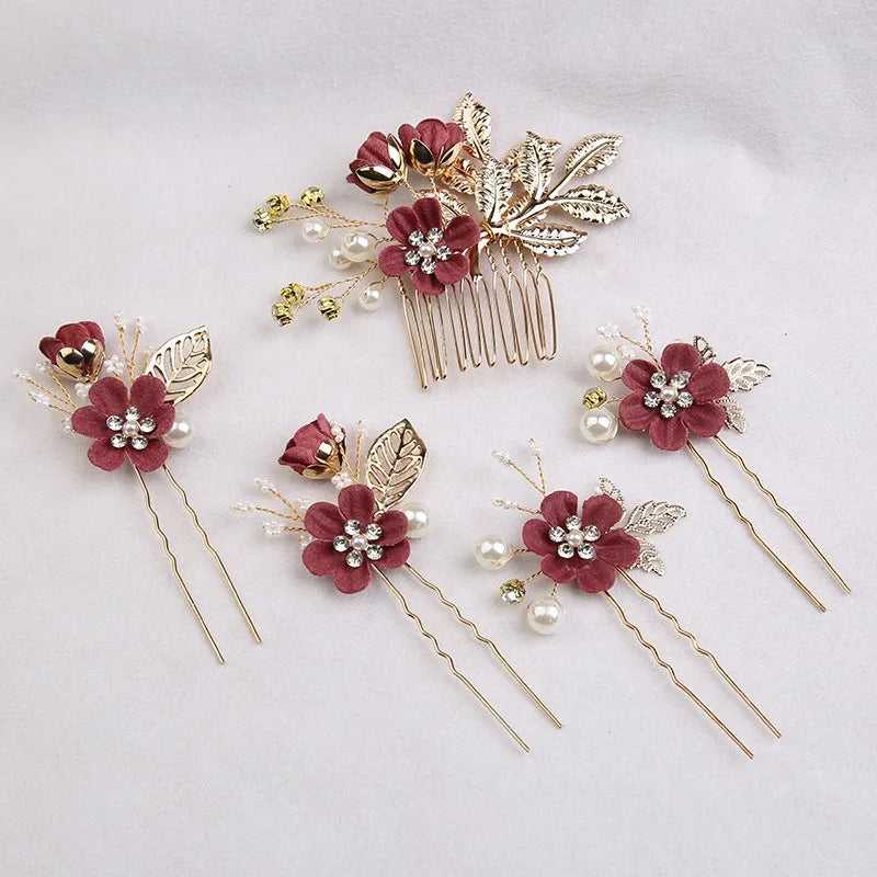 A set of five floral pearl bridal hair accessories featuring deep pink flowers and gold leaf accents.