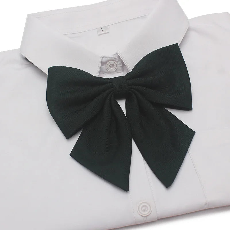 A black butterfly ribbon tie set displayed on a white dress shirt.