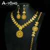A set of luxury gold plated bridal jewelry featuring earrings and a necklace with floral designs.