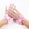 Pink bridal mesh finger gloves with floral accents displayed on a hand.