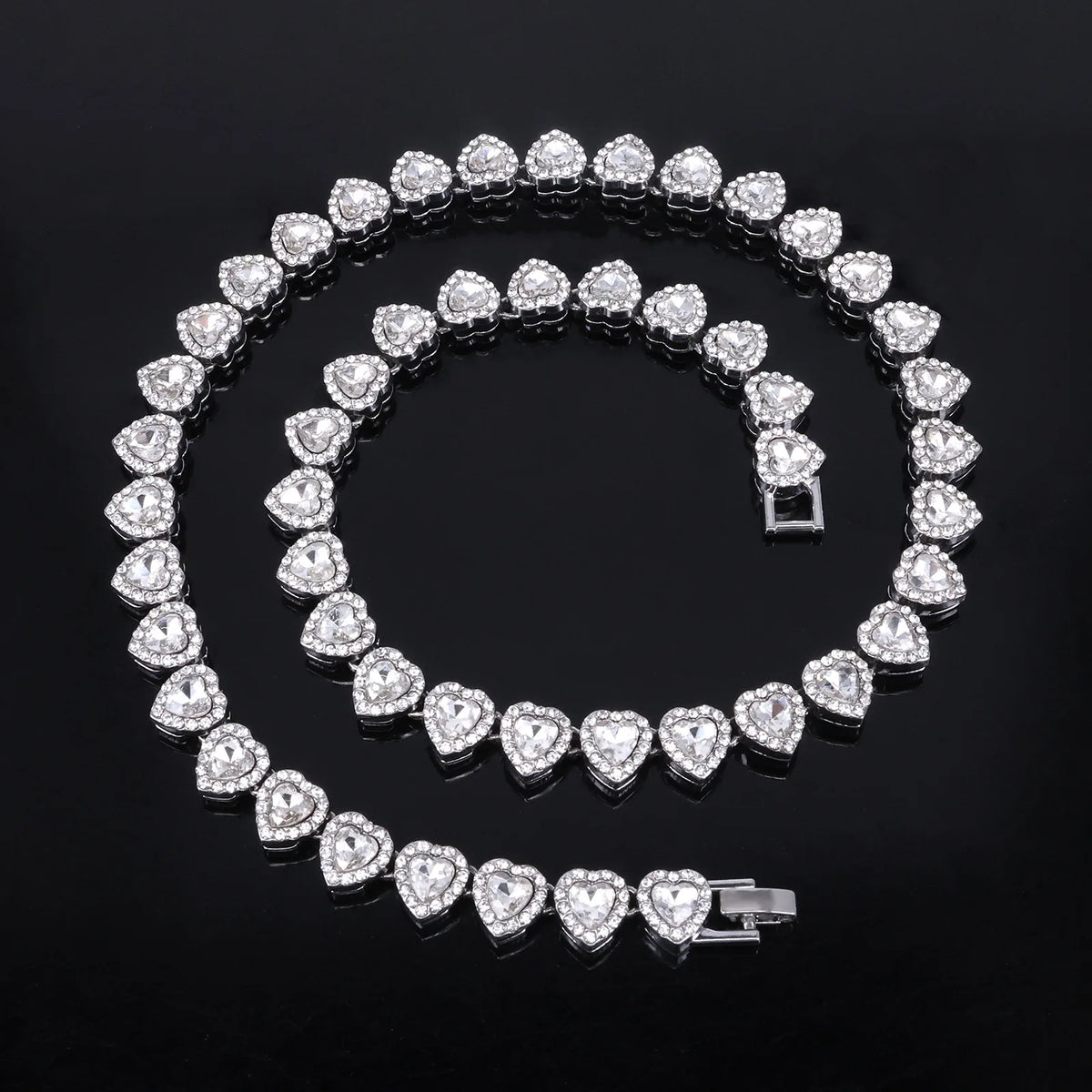 A set of sparkling heart rhinestone necklaces and bracelets arranged in an oval pattern.