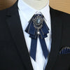 A black suit jacket with a navy blue bow tie featuring a silver rhinestone and pearl embellishment
