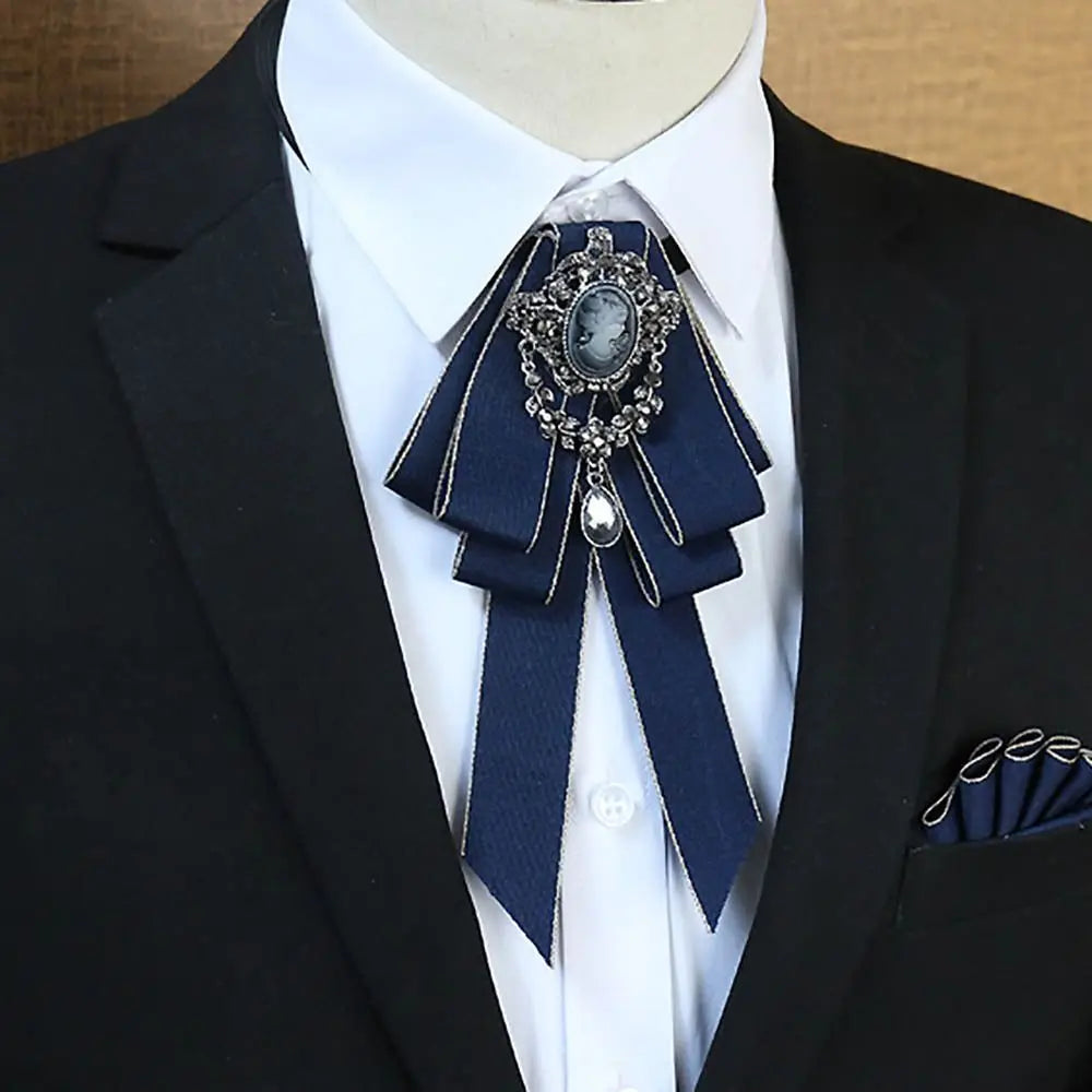 A black suit jacket with a navy blue bow tie featuring a silver rhinestone and pearl embellishment