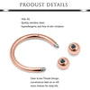 A close-up view of a rose gold colored barbell ring with a clear screw thread design.