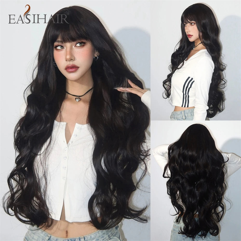 A woman modeling a long black wavy wig with bangs and a white top