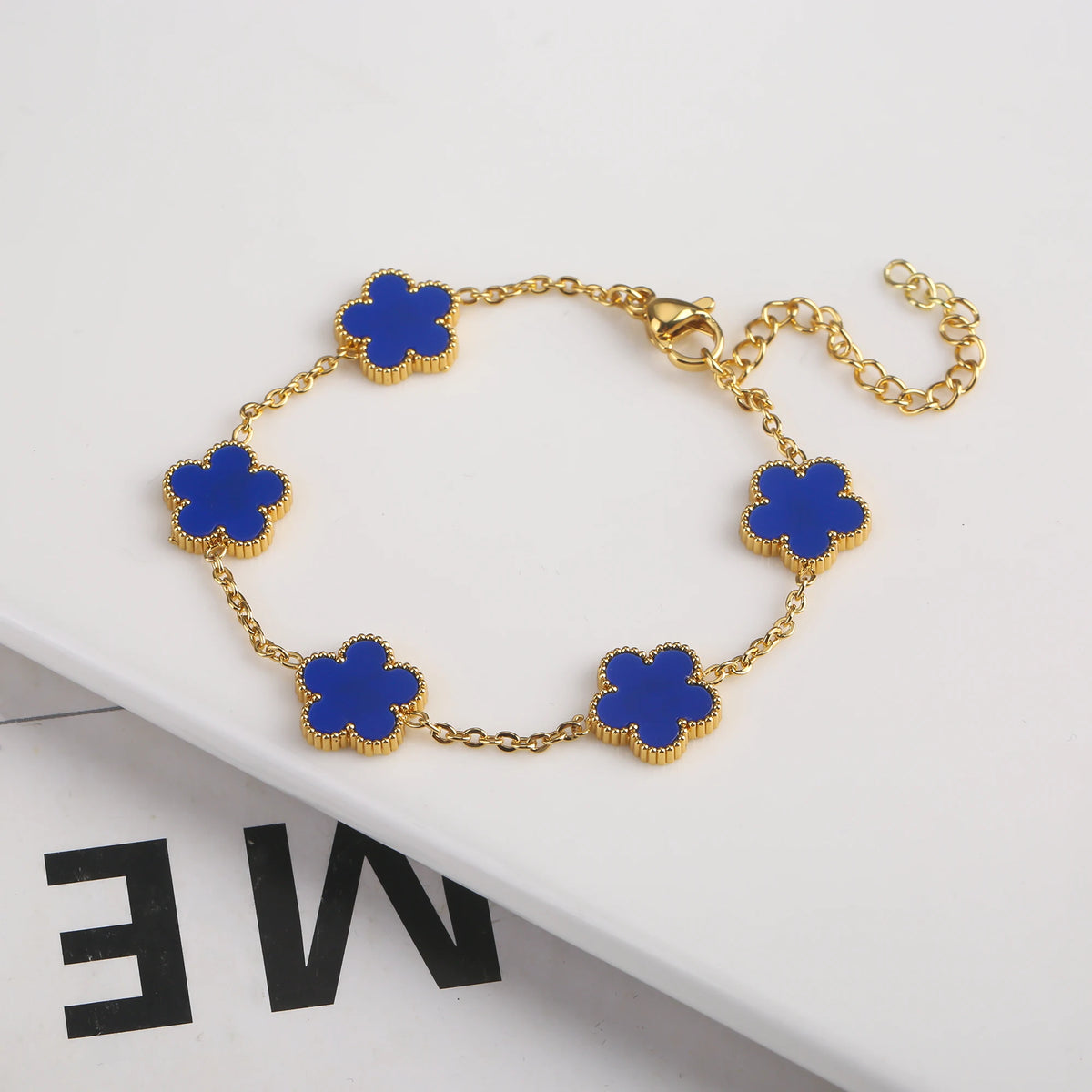 Pulsera de acero inoxidable chapada en oro con pequeños collares de flores azules