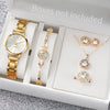 A set of elegant gold-toned quartz wrist watch and jewelry displayed in a white box.