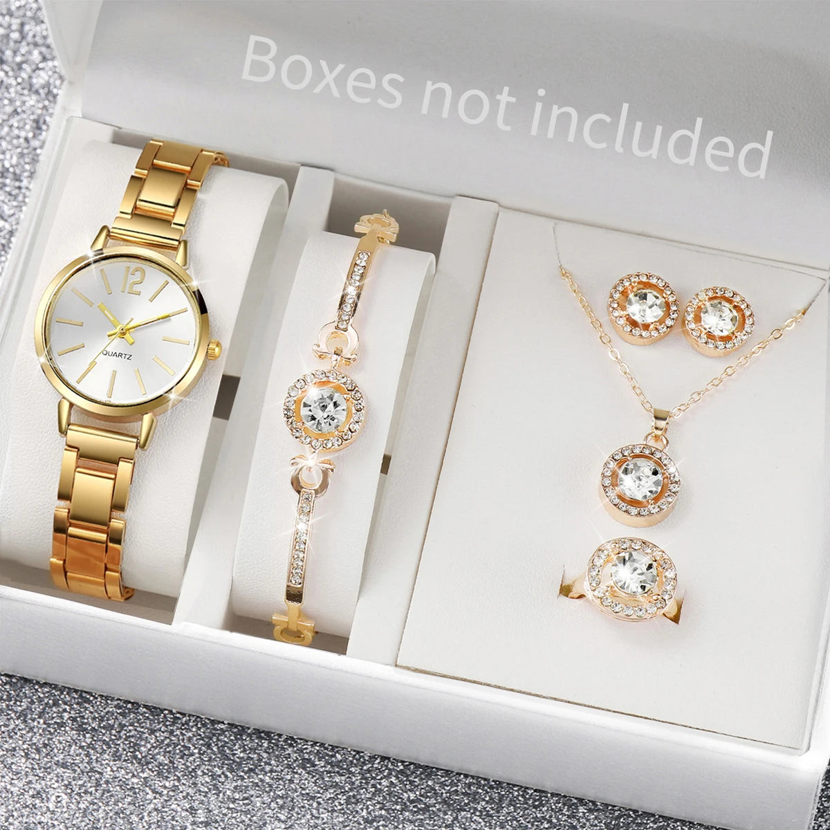 A set of elegant gold-toned quartz wrist watch and jewelry displayed in a white box.