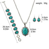 Silver necklace and earrings featuring turquoise stones with an ornate pendant.