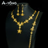 A set of luxury gold plated bridal jewelry featuring earrings and a necklace displayed on a black mannequin.