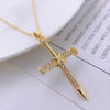 A delicate gold-colored cross charm necklace with small diamonds, displayed on a white background.