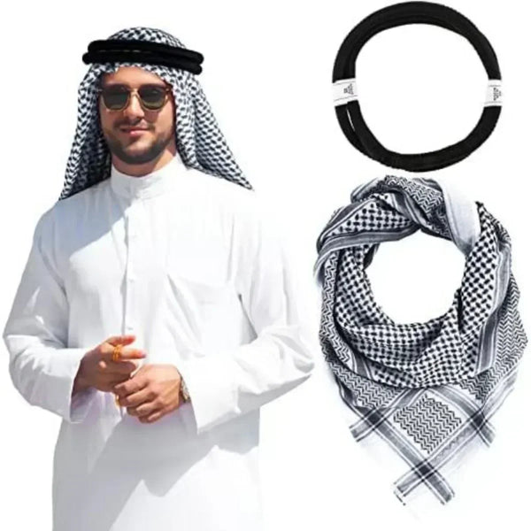 A man wearing a white thobe and traditional shemagh head scarf with an agal rope.