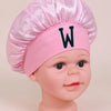Pink sleep cap for kids with a white letter W embroidered on the front