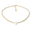 A delicate necklace made of mother of pearl beads with crystal accents and a small initial charm.