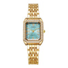 Reloj de cuarzo dorado con esfera azul claro y detalles de strass en bisel y pulsera.