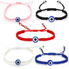 A collection of five Turkish Evil Eye charm bracelets in pink, black, red, white, and blue.