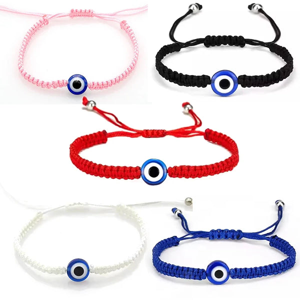 A collection of five Turkish Evil Eye charm bracelets in pink, black, red, white, and blue.