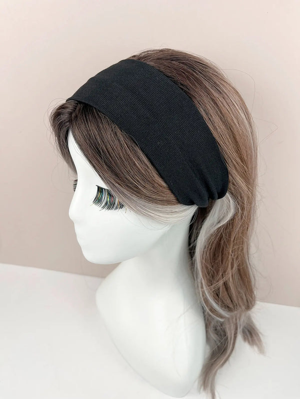 A model displays a black knitted hair band on her head, with long brown hair visible.