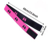 Pink adjustable lace headband with black ribbon details shown diagonally.