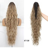 Long, wavy, light brown hair styled in a ponytail using a matte heat resistant synthetic ponytail holder.