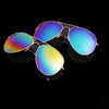 A pair of men's aviator sunglasses with gold and silver frames displayed against a black background.
