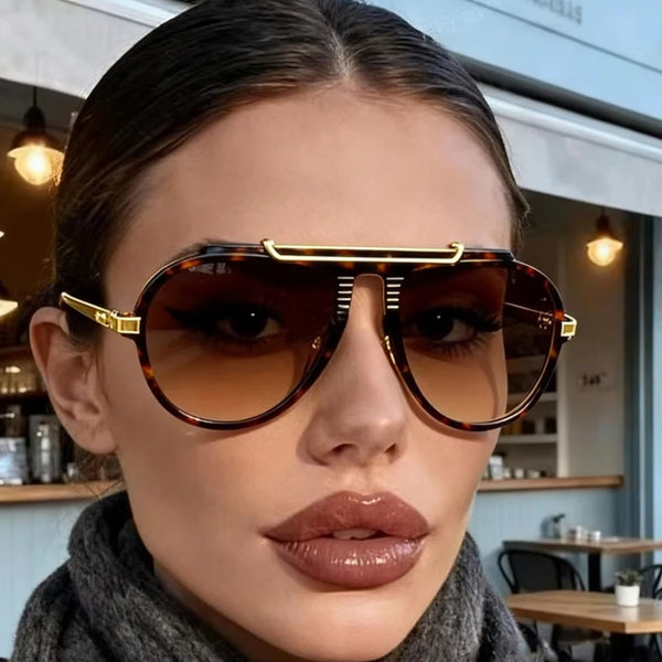 Close-up of a woman wearing vintage gradient pilot sunglasses with gold accents.