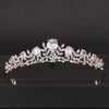 A delicate silver bridal crown adorned with clear and lavender crystals.