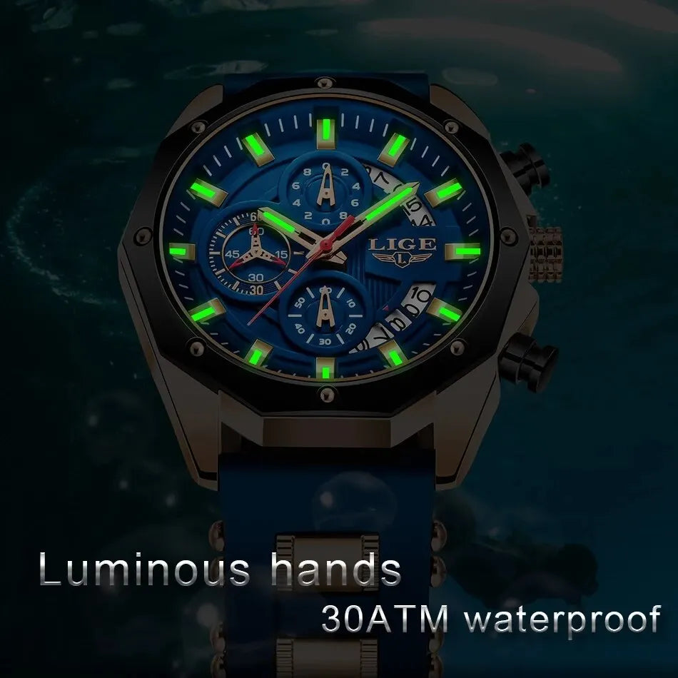 A close-up of a blue and black watch with luminous green hands and a dark face set against a blurred background.