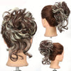 A display of synthetic messy hair bun scrunchies in brown and gray colors shown on a mannequin head.