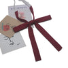 A set of classic butterfly ribbon ties in deep burgundy and white for students.