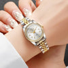 A close-up of a silver and gold rhinestone quartz wristwatch worn on a woman's wrist.