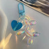 A light blue keychain featuring a translucent, iridescent jelly cartoon dog charm attached to a split ring.