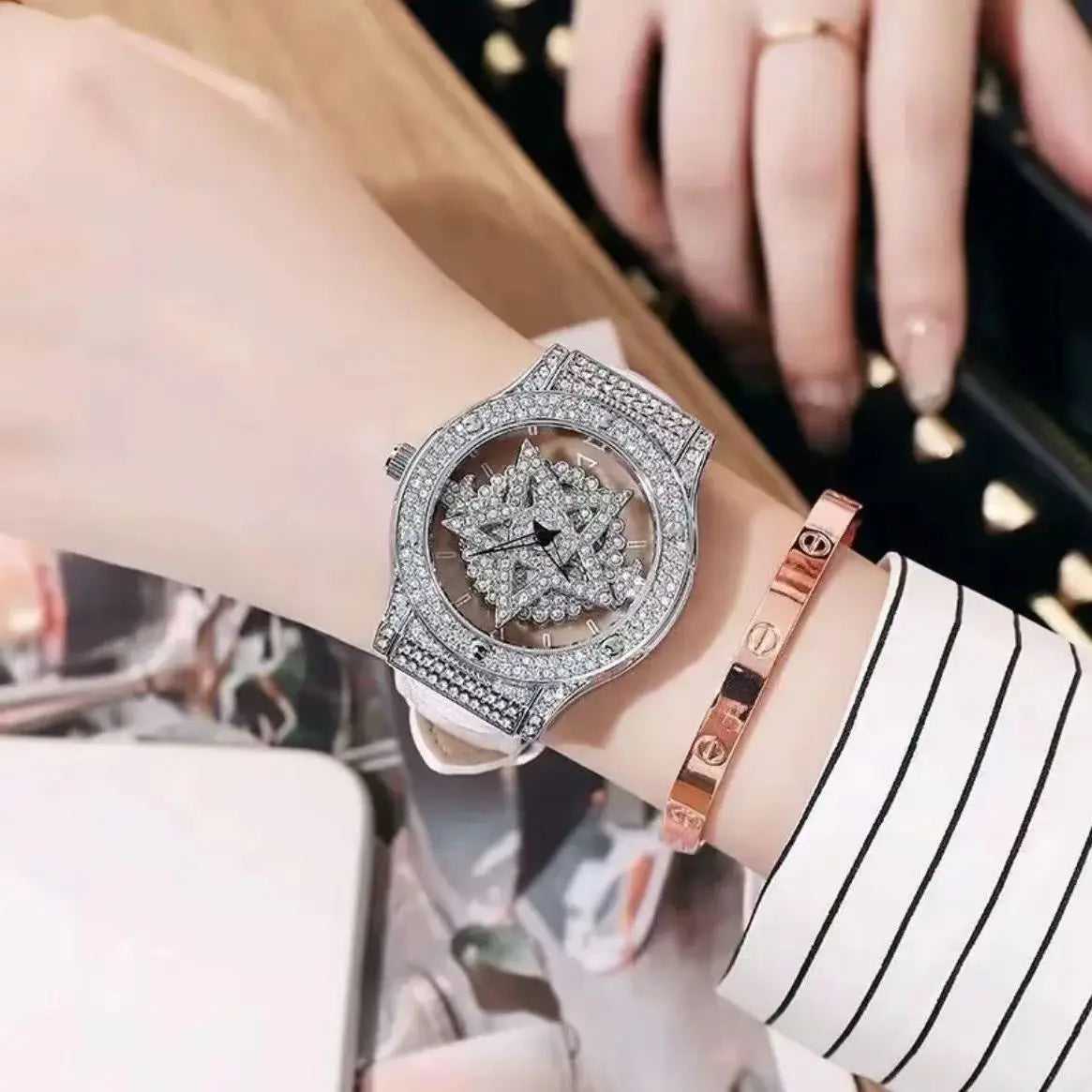 A close-up of a luxury women's watch with a diamond-encrusted rotating bezel and rose gold band on a wrist.