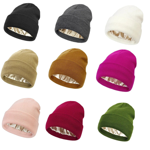 A collection of nine knitted beanie hats in various colors including black, gray, cream, olive green, and magenta.