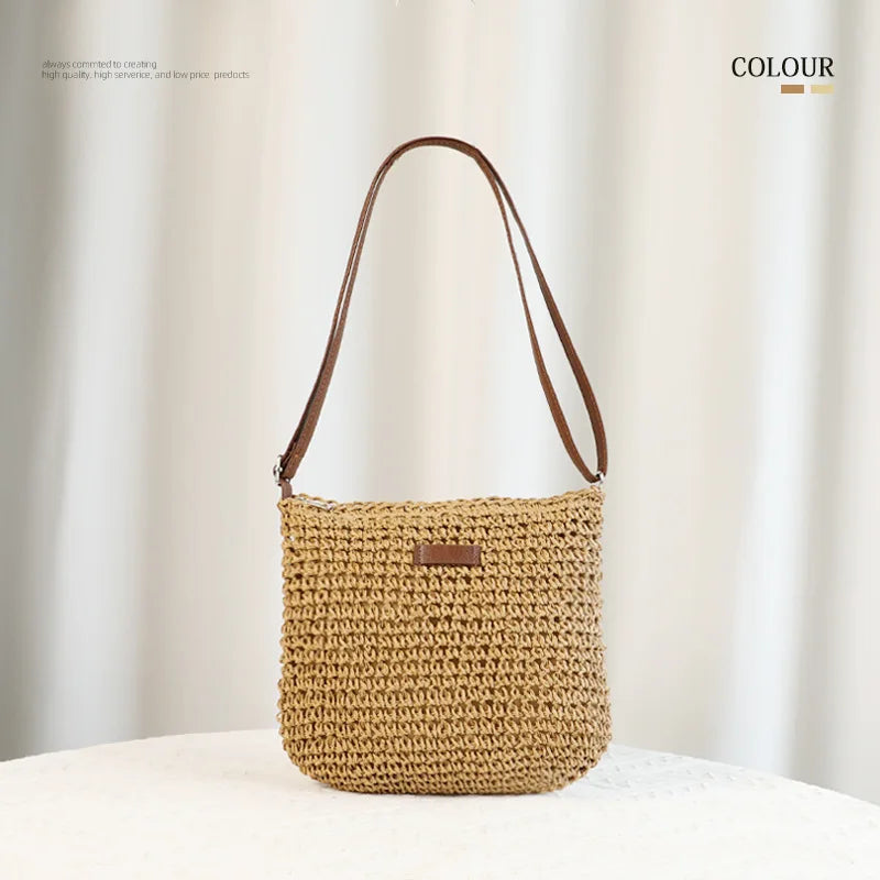 A hand-woven straw visor hat in a natural beige color displayed on a white surface.