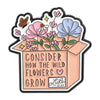 A pink and blue enamel flower brooch set featuring wildflowers and a message encouraging wild flowers to grow.