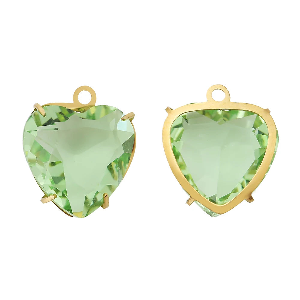 A pair of heart-shaped crystal pendants with a green hue set in gold-toned stainless steel.