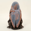 A soft gray floral embroidered lace bandana headscarf tied around dark hair.